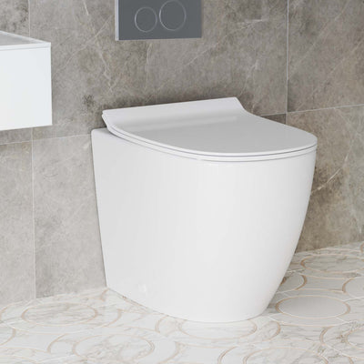Elongated back-to-wall toilet in glossy white with concealed tank and soft-close seat.