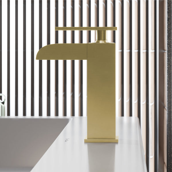 Single-handle waterfall bathroom faucet in brushed gold with sleek modern design and flat spout.