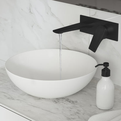 Wall-mount bathroom faucet in matte black, single-handle design, sleek angular spout with flowing water.