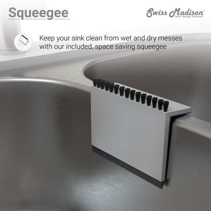 Stainless steel farmhouse kitchen sink squeegee with black bristles and white body attached inside sink basin.