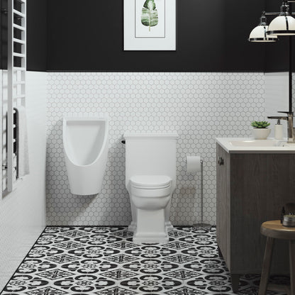 White wall-hung waterless urinal with smooth curved design mounted in modern bathroom.