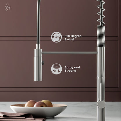 Pull-down single handle kitchen faucet in brushed nickel with spring coil neck and spray/stream function.
