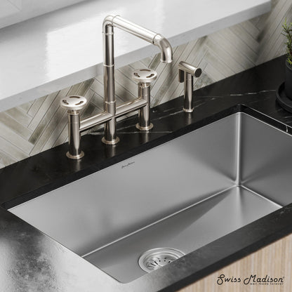 Widespread kitchen faucet in brushed nickel with high-arc spout and side sprayer by Avallon Pro.