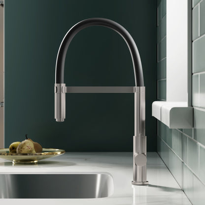 Single handle pull-down kitchen faucet in brushed nickel with curved gooseneck design.