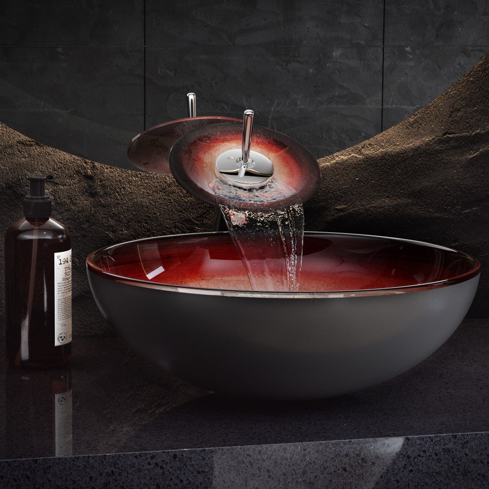 16.5-inch ember red glass vessel sink with matching waterfall faucet on black countertop.