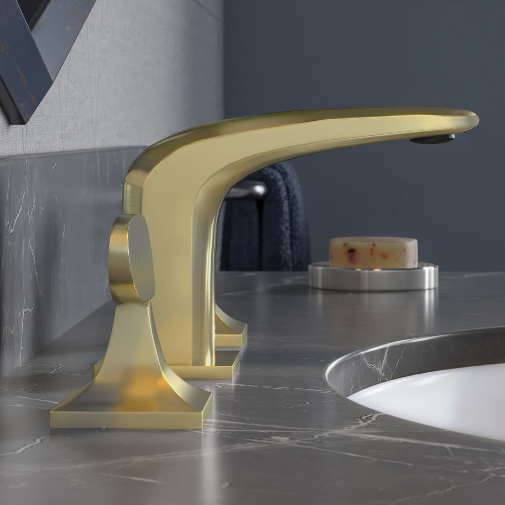 Widespread bathroom faucet in brushed gold with two handles and curved spout on gray countertop.