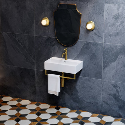 22" wall-mount bathroom sink with brushed gold towel bar and matching faucet on dark tile wall.