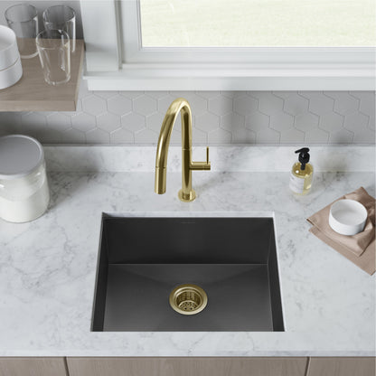 Single basin undermount kitchen sink in black stainless steel with gold drain and faucet.