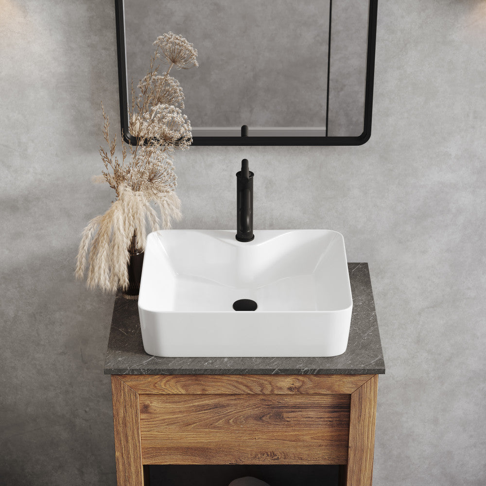 19-inch glossy white vessel sink with square shape and rounded corners on wooden vanity.