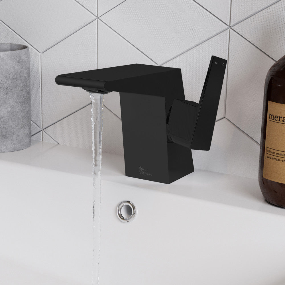 Single-handle bathroom faucet in matte black, angular modern design with water flowing from spout.