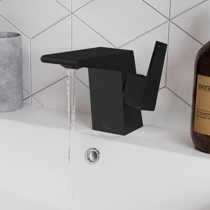 Single-handle bathroom faucet in matte black, angular modern design with water flowing from spout.