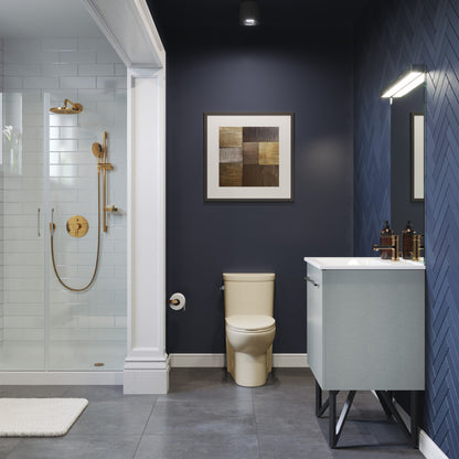 Elongated one-piece toilet in bisque with left side flush handle, compact design.