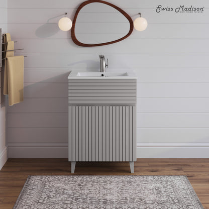24-inch freestanding bathroom vanity in shell with single sink and vertically grooved cabinet doors.
