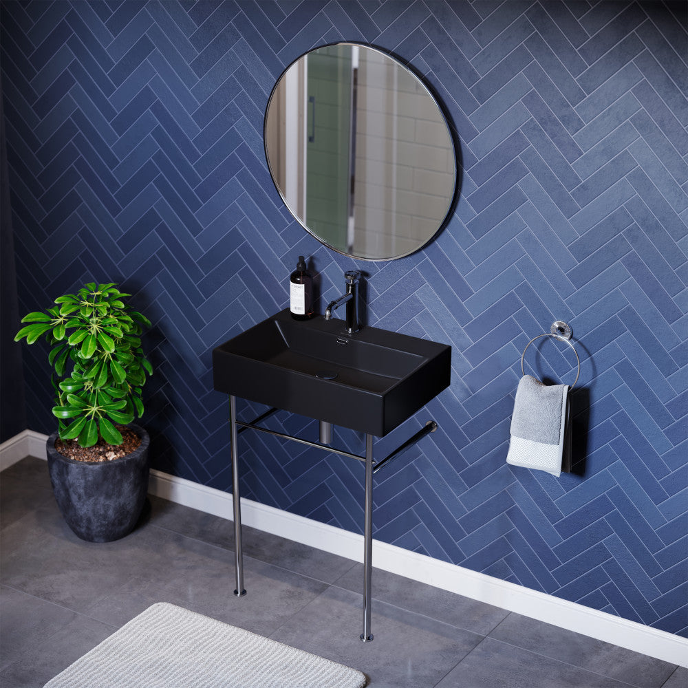 Matte black ceramic console sink with chrome legs, rectangular basin, wall-mounted vanity style.