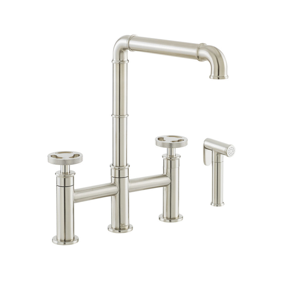 Widespread kitchen faucet in brushed nickel with side sprayer and tall arched spout.