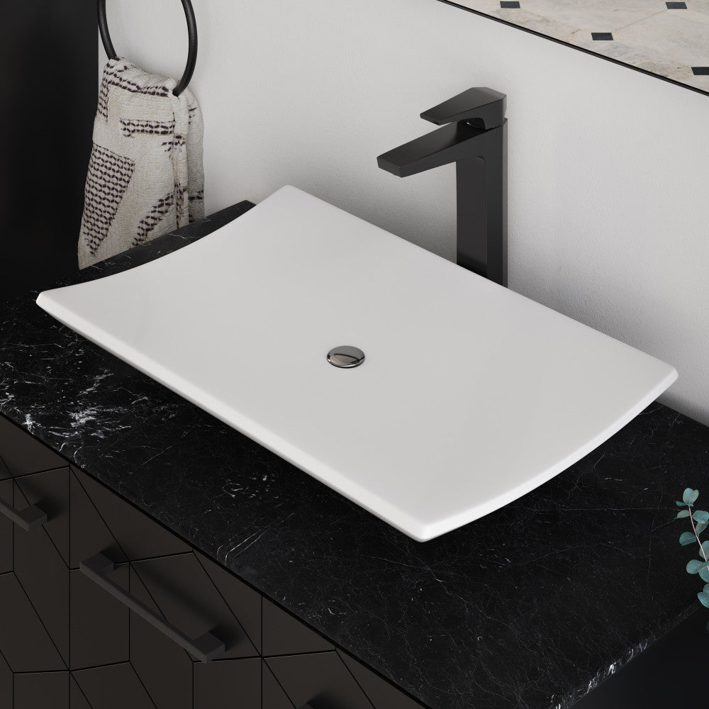 23.5” white rectangular vessel bathroom sink with smooth curved edges on black marble countertop.