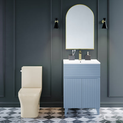 Elongated one-piece toilet in bisque with left side flush handle and skirted trapway.