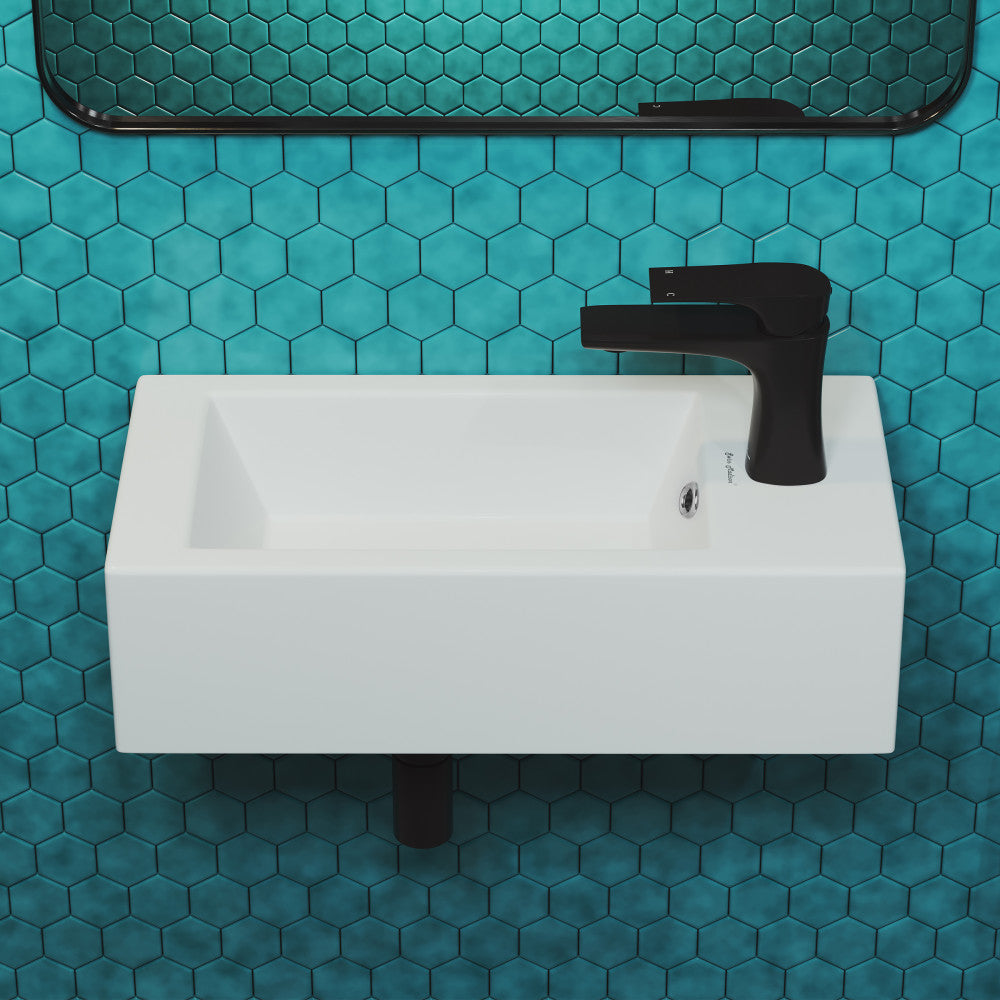 19.5x10 rectangular ceramic wall-hung sink with right-side black faucet mount on blue hex tile wall.