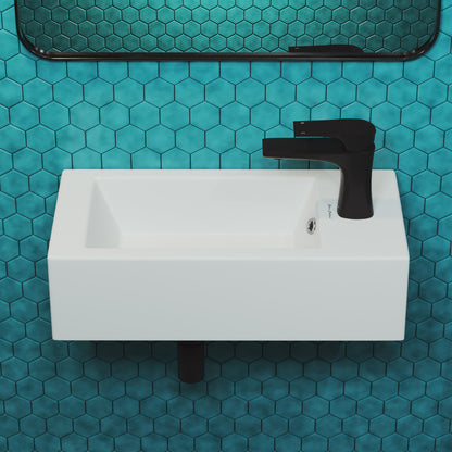19.5x10 rectangular ceramic wall-hung sink with right-side black faucet mount on blue hex tile wall.