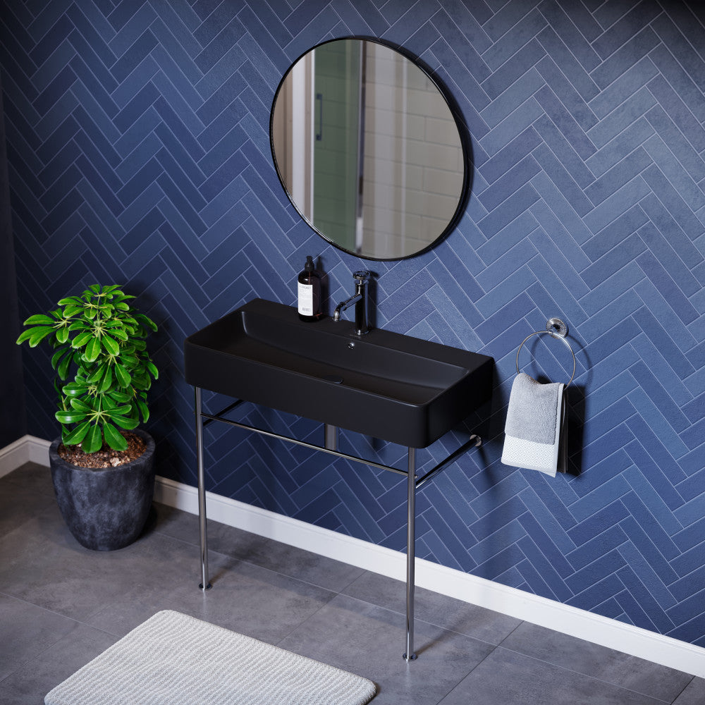 36-inch matte black ceramic console sink with chrome legs and single faucet hole.