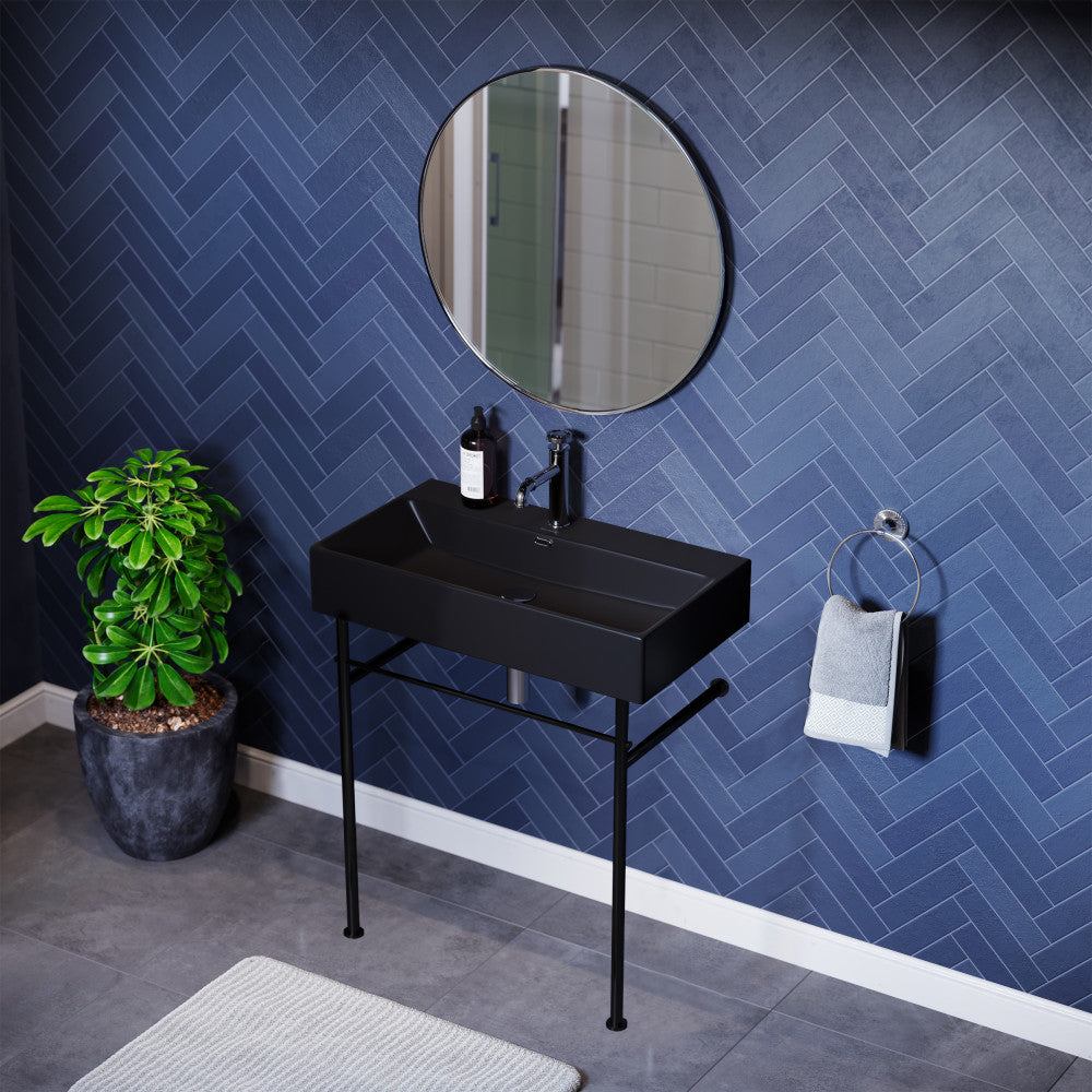 Matte black ceramic console sink with rectangular basin and slim black metal legs.