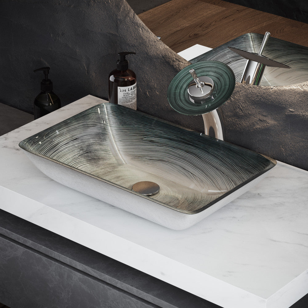Rectangular smoky gray glass vessel sink with tall single-handle faucet on marble countertop.