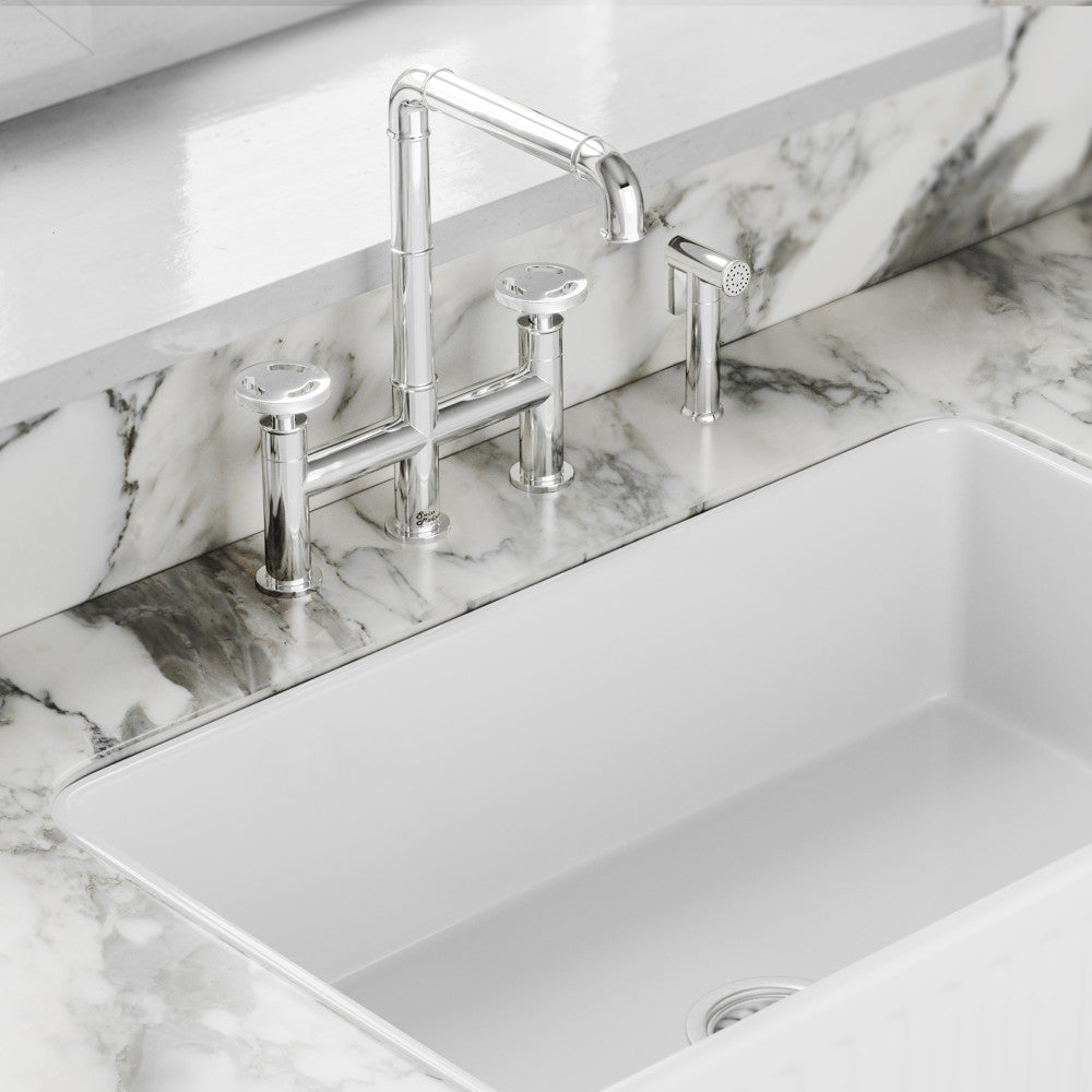 Widespread kitchen faucet with side sprayer in chrome, high-arc spout and dual handles.