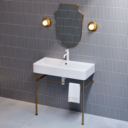 36-inch white ceramic console sink with brushed gold legs and single faucet hole.