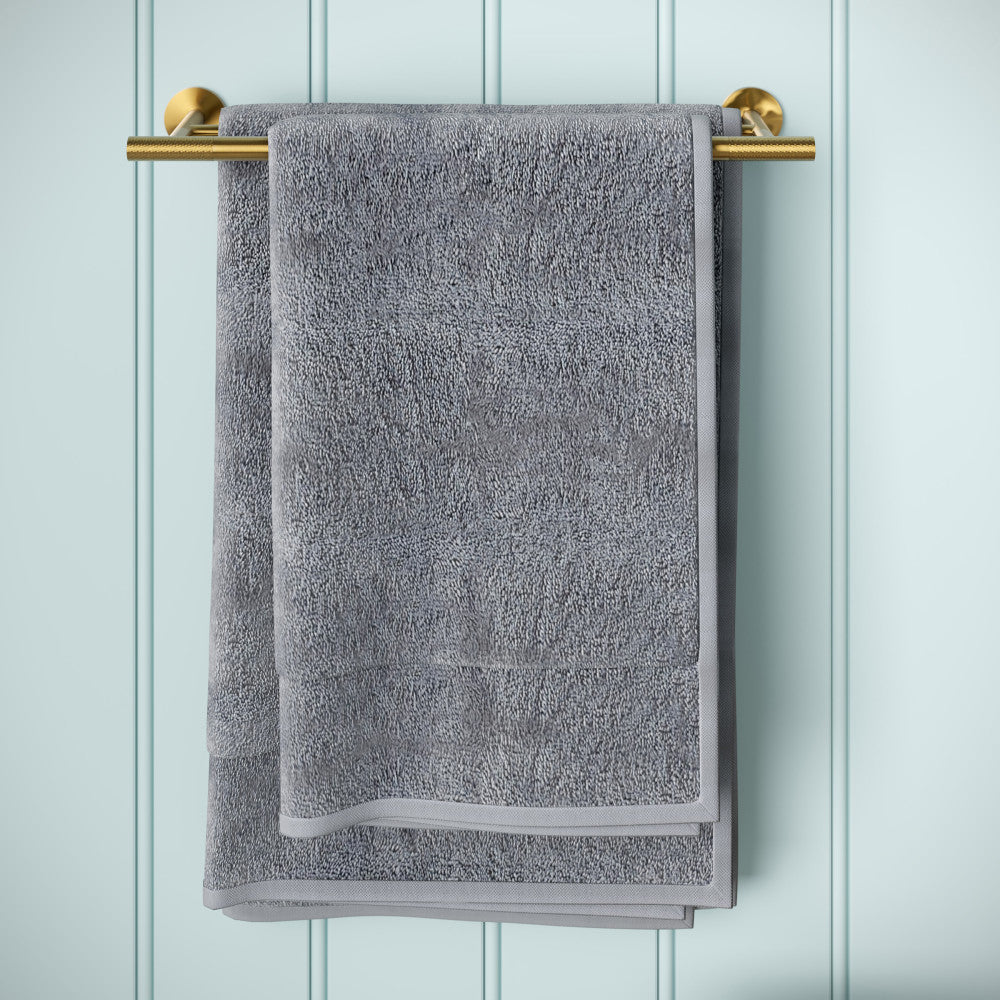 Double towel bar in brushed gold with round mounting brackets and minimalist design.