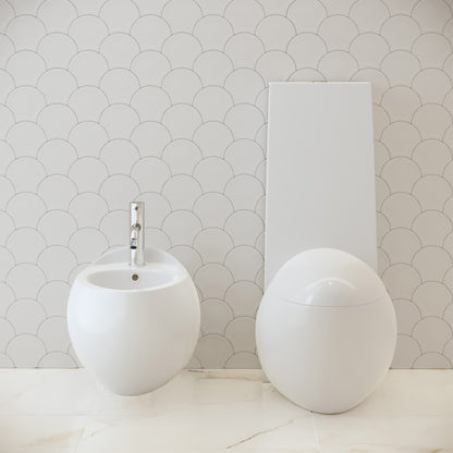 Round wall-hung bidet with a single faucet hole and smooth curved design in white ceramic.