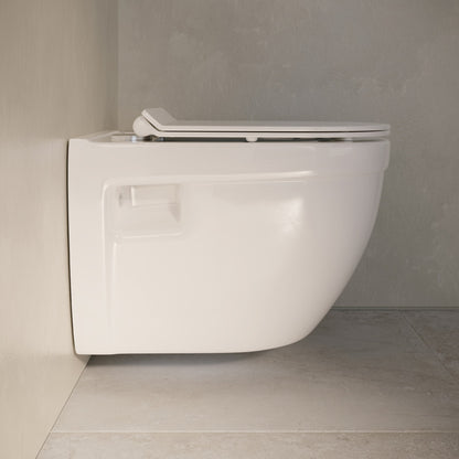 White wall-hung elongated toilet bowl with soft-close seat mounted on light grey tiled wall.