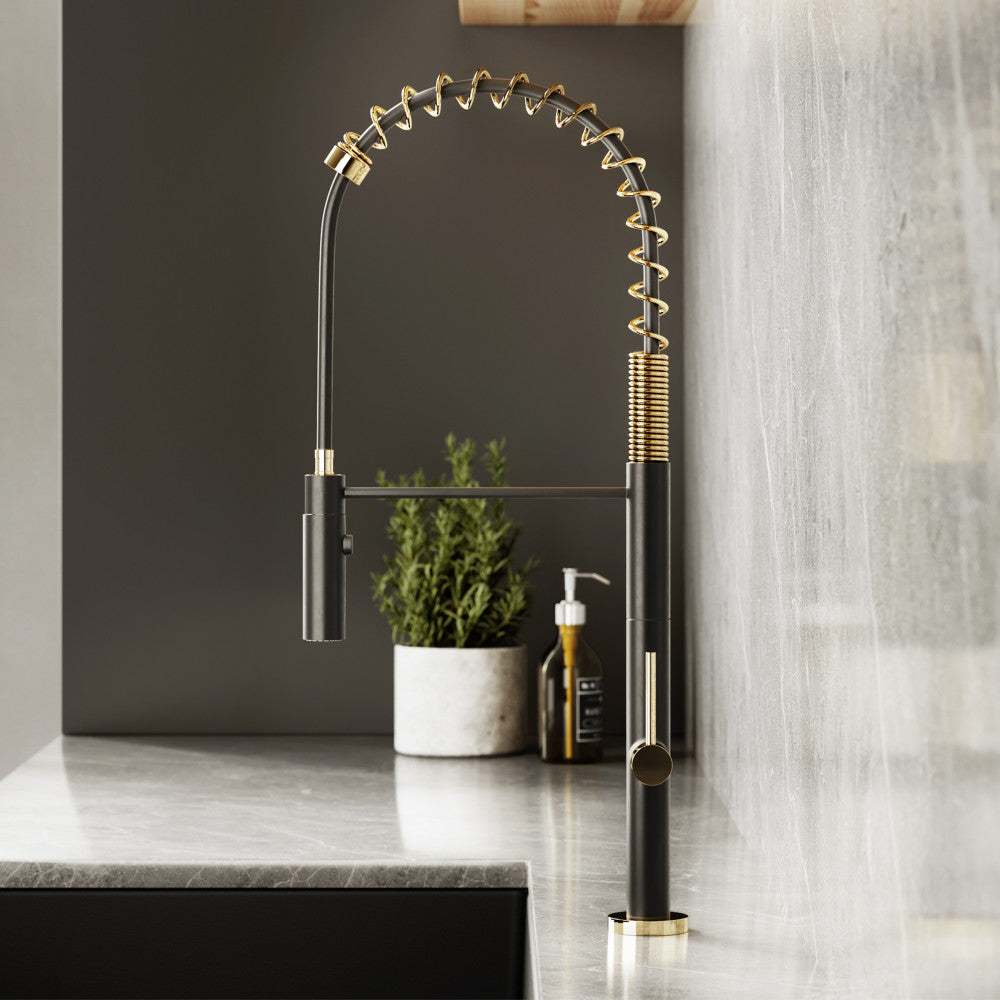 Single handle pull-down kitchen faucet in brushed gold and black with spring spout design.