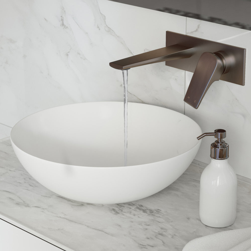 Single-handle wall-mount bathroom faucet in oil rubbed bronze with curved spout and lever handle.