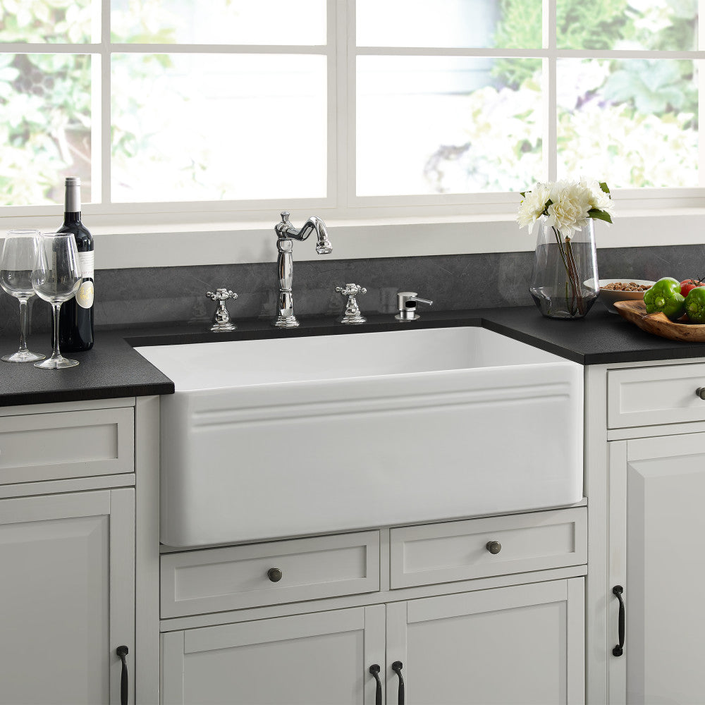 30 x 18 white ceramic farmhouse kitchen sink with apron front, shown installed in white cabinetry.