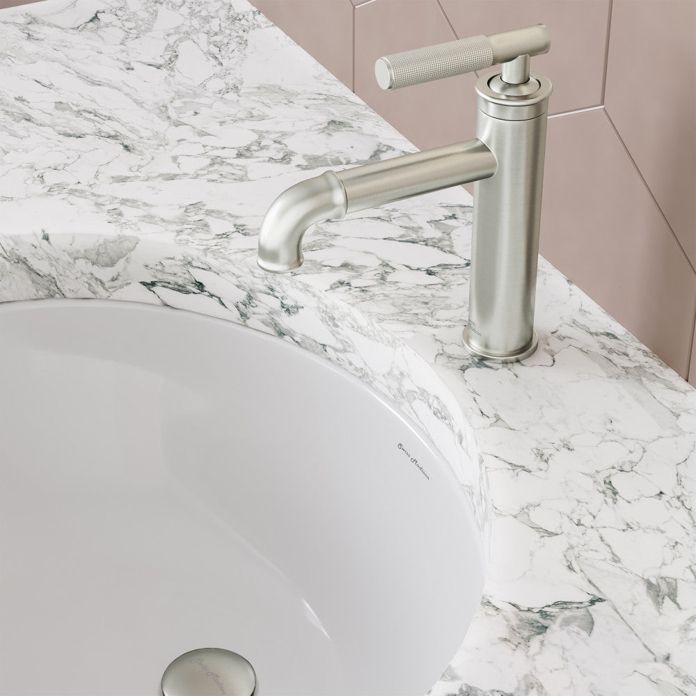 Single-handle bathroom faucet in brushed nickel with sleek cylindrical design and curved spout.