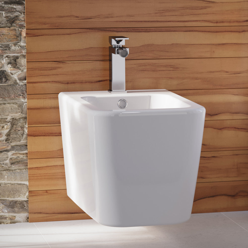 Wall-hung Concorde bidet with classic design and chrome faucet on wooden wall background.