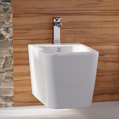 Wall-hung Concorde bidet with classic design and chrome faucet on wooden wall background.