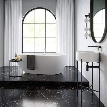 16.5" round white console sink with matte black legs in modern bathroom setting.