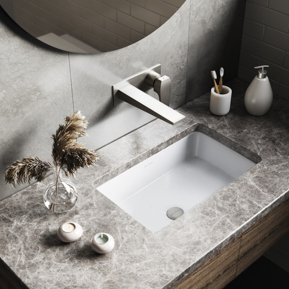 Rectangular under-mount bathroom sink in white, integrated with gray marble countertop.