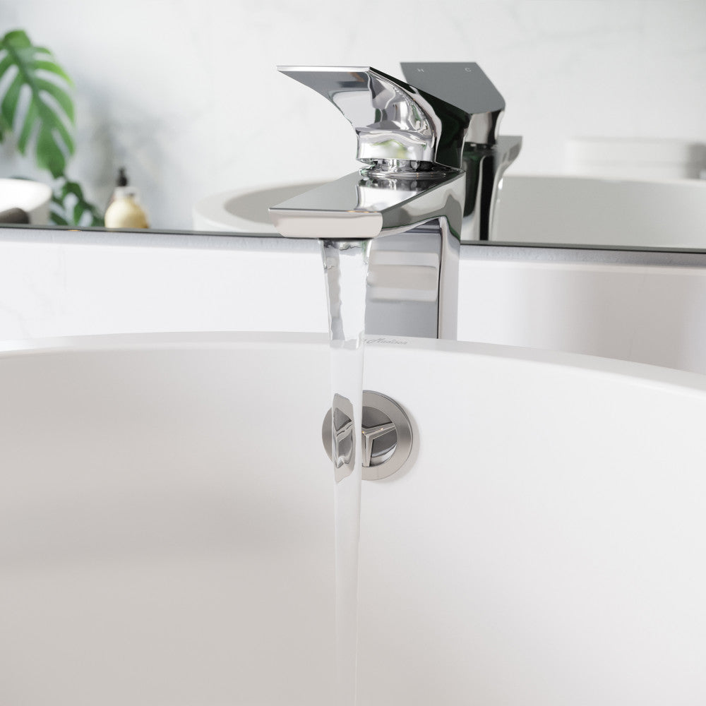Monaco single-handle bathroom faucet in chrome with high arc spout and water flowing from it.