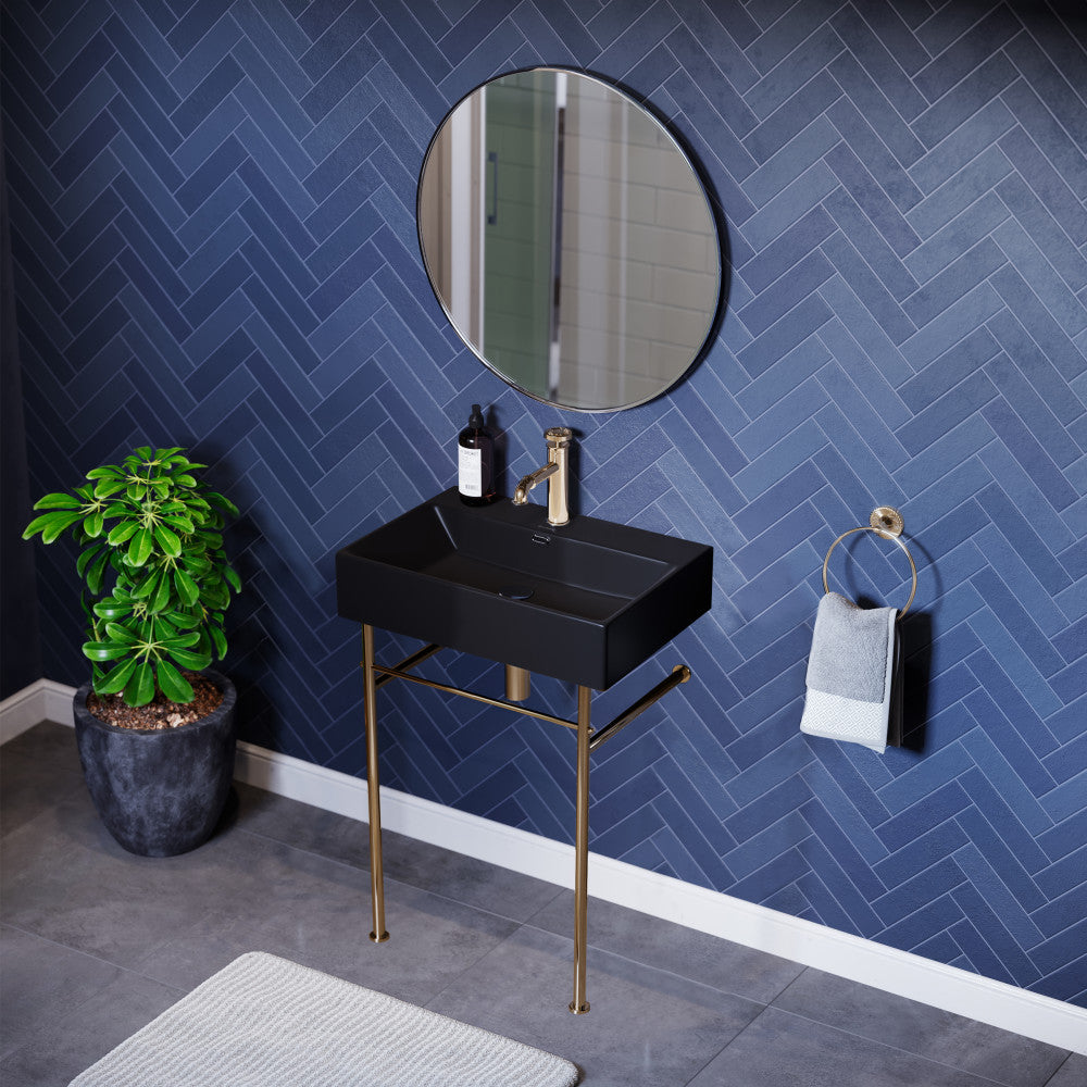 Matte black ceramic console sink with gold metal legs, rectangular basin, modern design.