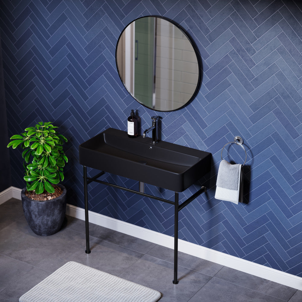 36-inch matte black ceramic console sink with slim black legs and minimalist rectangular basin.