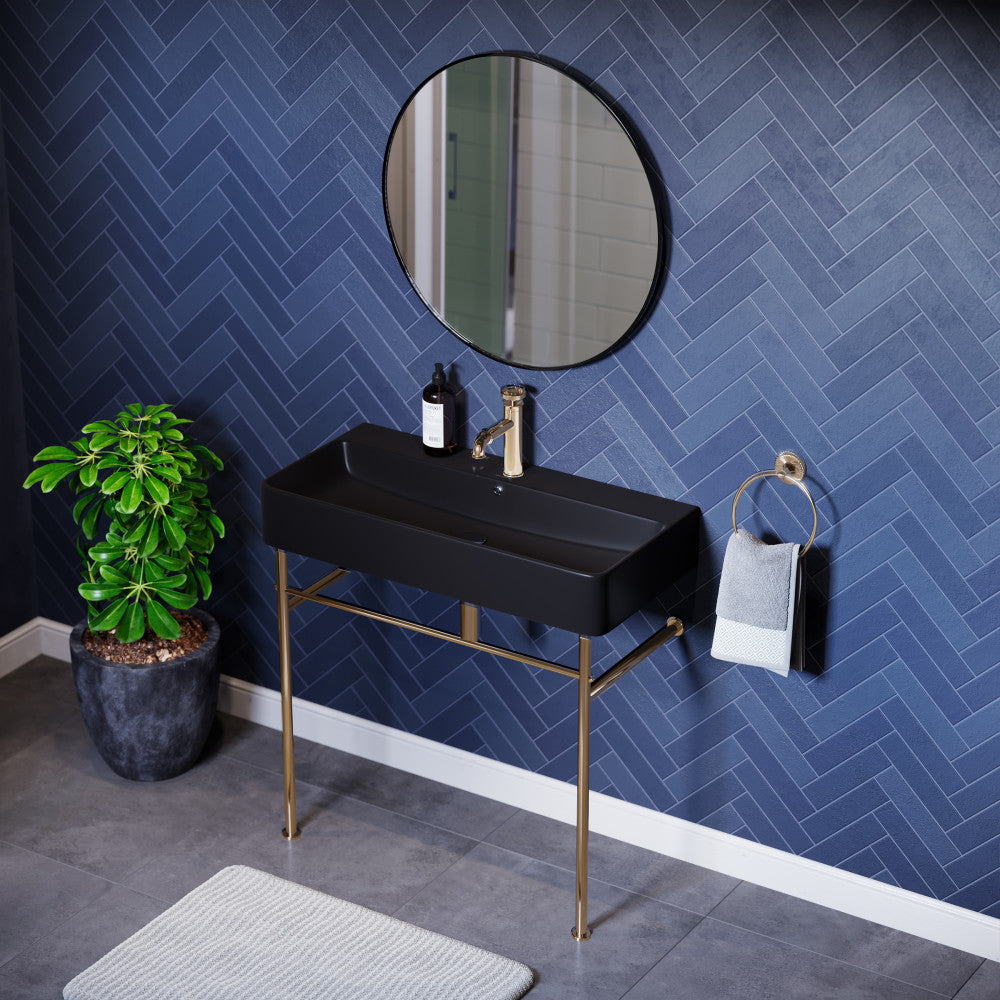 Matte black ceramic console sink with gold legs, rectangular basin, single faucet hole.