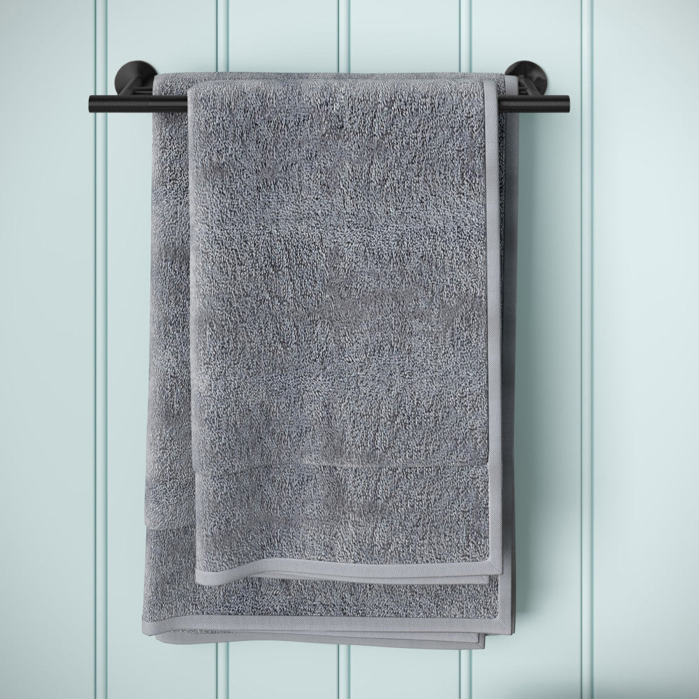 Double towel bar in matte black, wall mounted, holding gray folded towel.