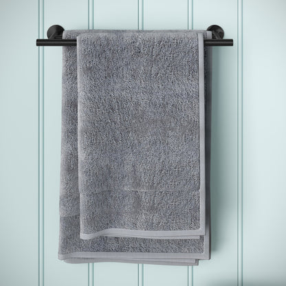 Double towel bar in matte black, wall mounted, holding gray folded towel.