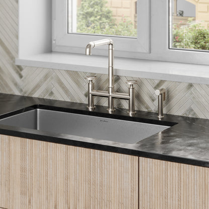 Widespread kitchen faucet in brushed nickel with high arc spout and side sprayer.