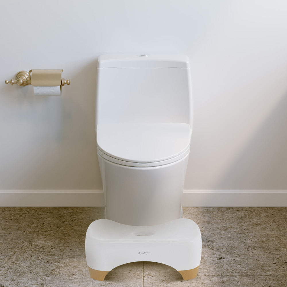Aqua 7" toilet stool in oak wood with curved design placed in front of modern white toilet.