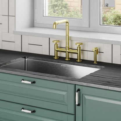 Widespread kitchen faucet in brushed gold with high-arc spout and side sprayer.