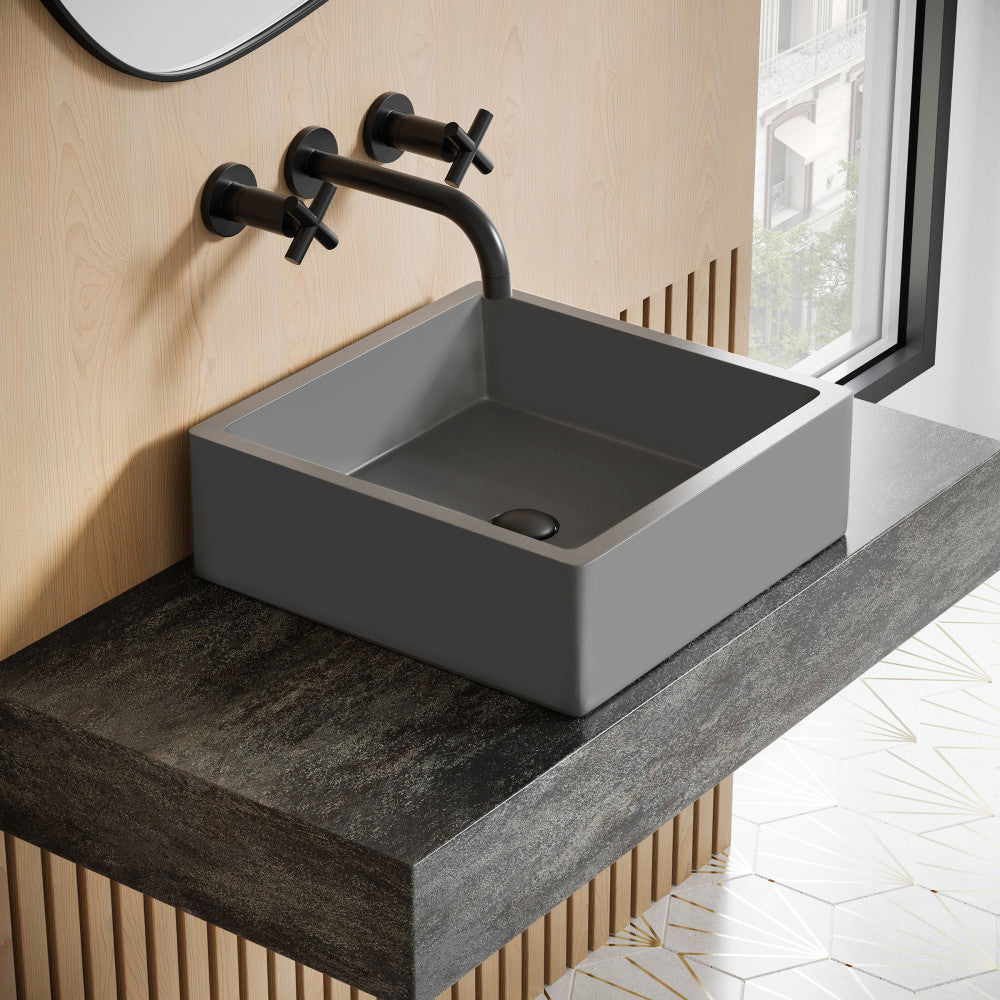15.5" square concrete vessel bathroom sink in dark gray with matte black wall-mounted faucet.