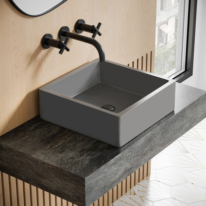 15.5" square concrete vessel bathroom sink in dark gray with matte black wall-mounted faucet.